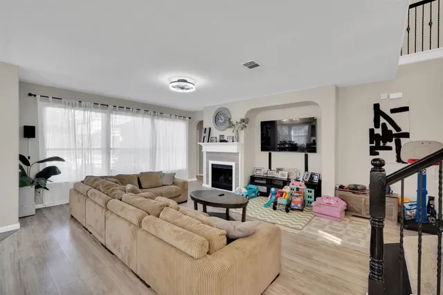 a living room with fireplace furniture and a flat screen tv