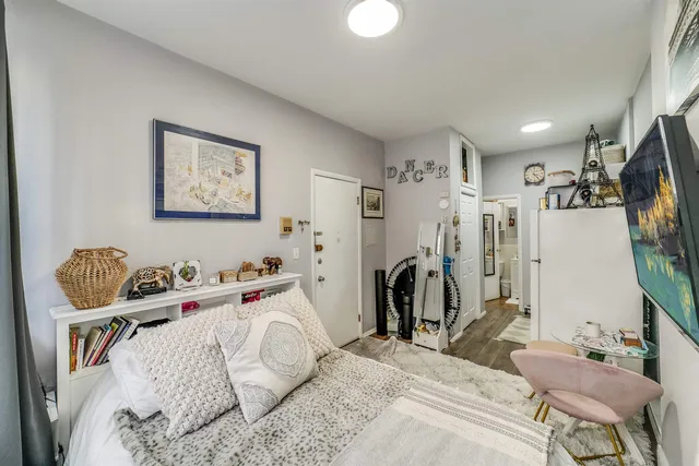 a bedroom with a bed and a flat screen tv