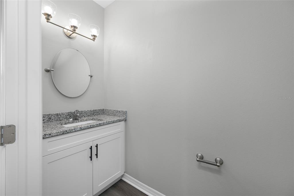 2115 Sebring Place Clearwater, FL 33760 - Photo 14 of 59 a bathroom with a granite countertop sink and mirror
