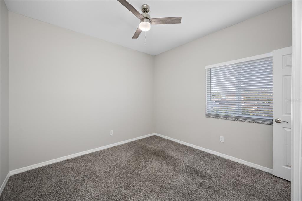 2115 Sebring Place Clearwater, FL 33760 - Photo 27 of 59 an empty room with a window and a ceiling fan