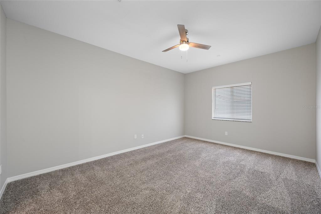 2115 Sebring Place Clearwater, FL 33760 - Photo 28 of 59 an empty room with windows and fan