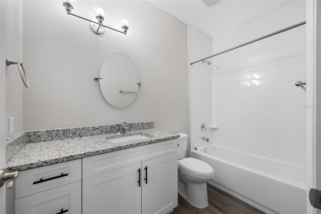 2115 Sebring Place Clearwater, FL 33760 - Photo 31 of 59 a bathroom with a granite countertop sink toilet and shower