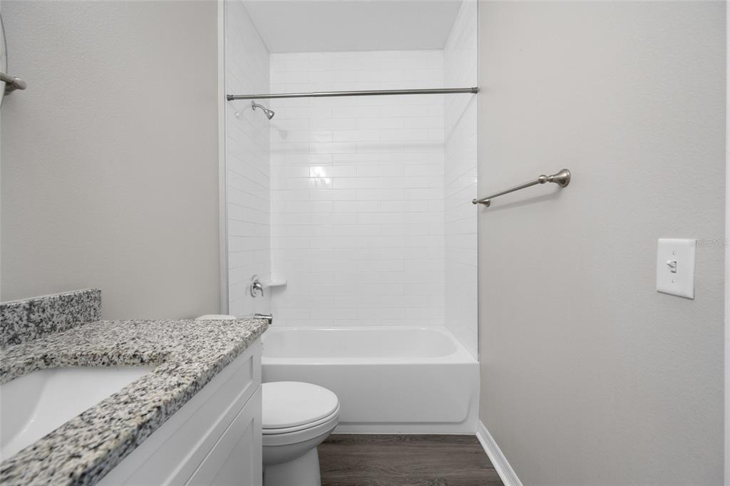 2115 Sebring Place Clearwater, FL 33760 - Photo 32 of 59 a bathroom with a granite countertop sink toilet and shower