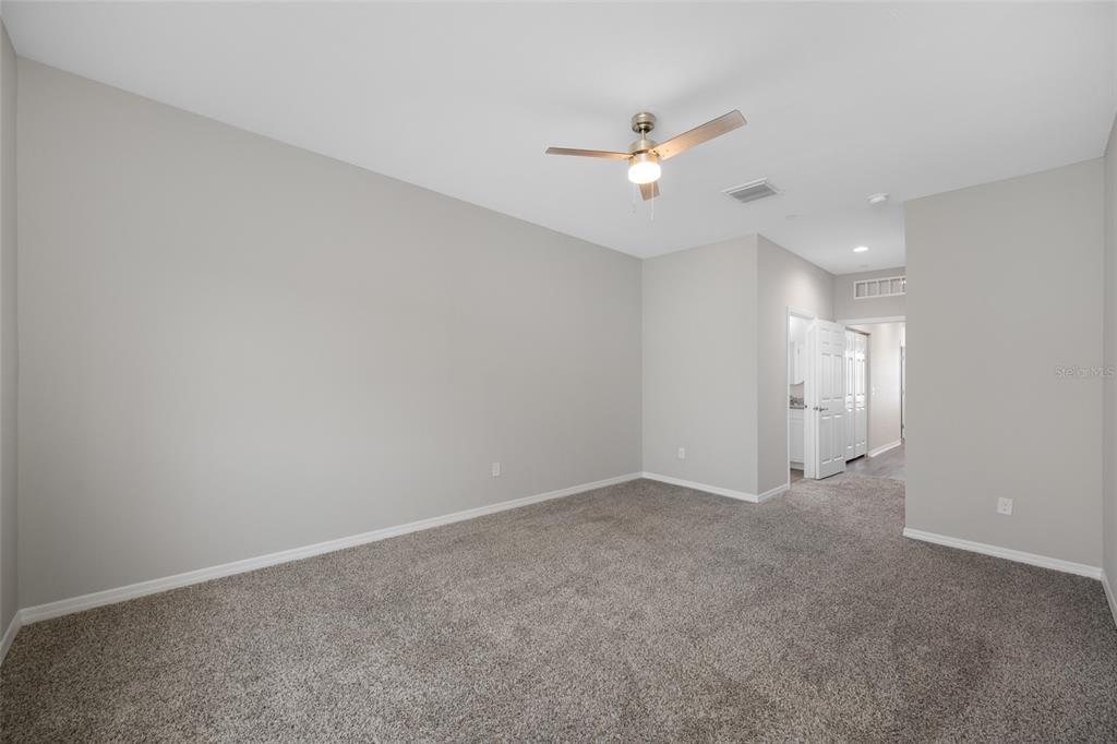 2115 Sebring Place Clearwater, FL 33760 - Photo 37 of 59 an empty room with a ceiling fan and bathroom