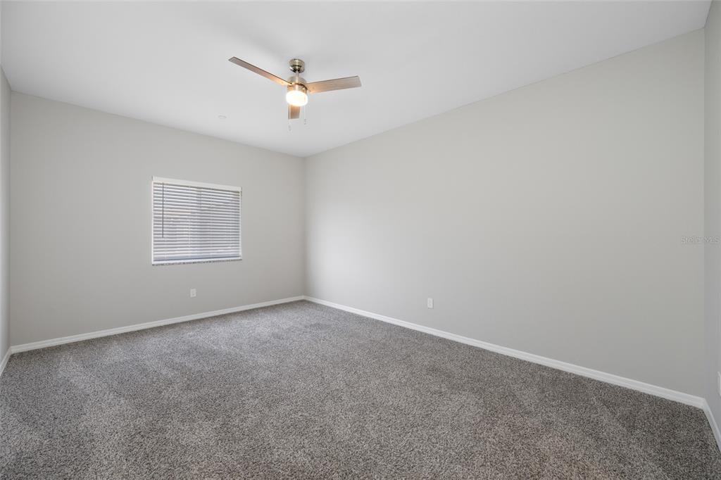 2115 Sebring Place Clearwater, FL 33760 - Photo 38 of 59 an empty room with a window and a fan