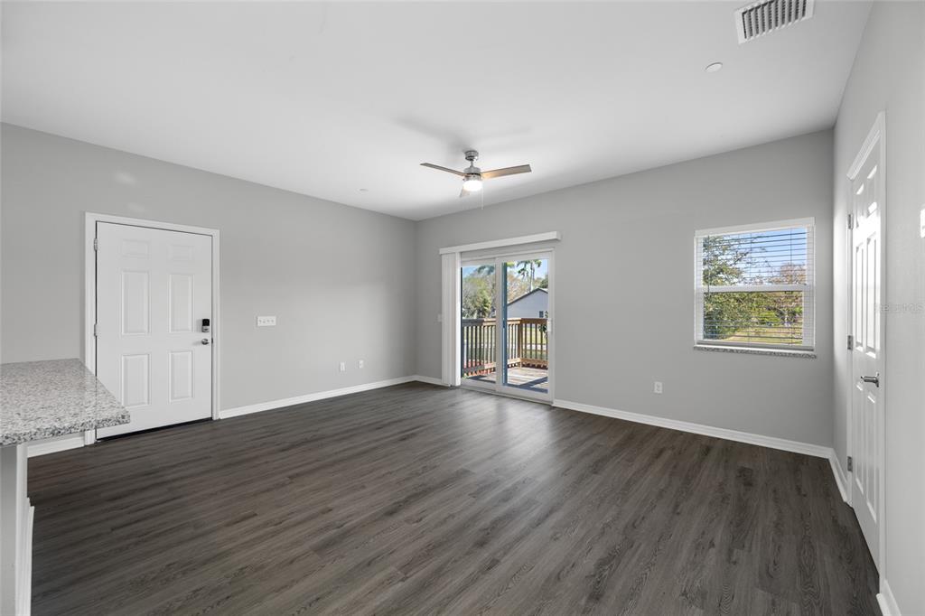 2115 Sebring Place Clearwater, FL 33760 - Photo 4 of 59 an empty room with wooden floor and windows