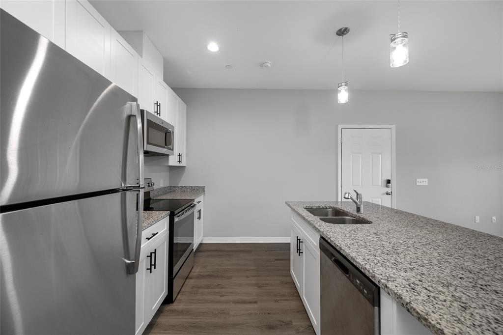 2115 Sebring Place Clearwater, FL 33760 - Photo 6 of 59 a kitchen with stainless steel appliances granite countertop a refrigerator a stove and a sink