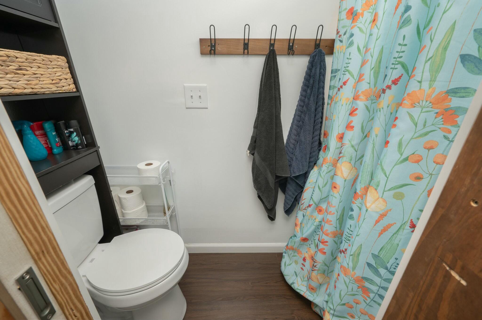 6188 Old River Road Baker, FL 32531 - Photo 15 of 34 a bathroom with a toilet and a shower curtain