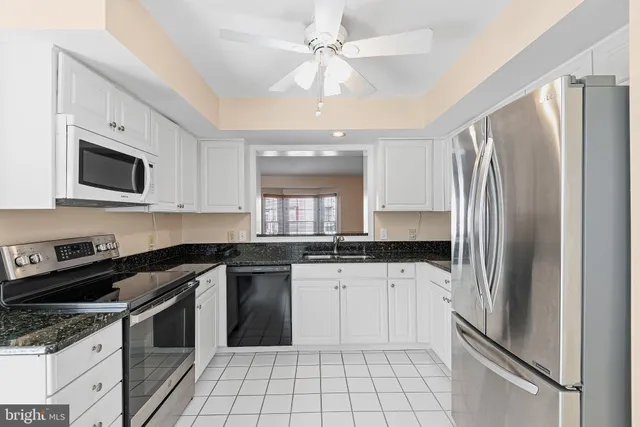 a kitchen with a sink stove and refrigerator