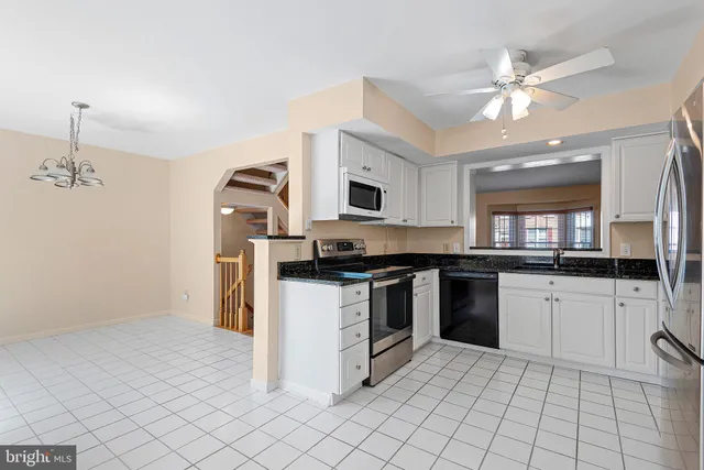 a kitchen with a sink cabinets and stainless steel appliances