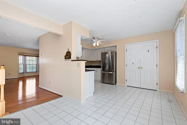 a view of a kitchen with a sink and a refrigerator