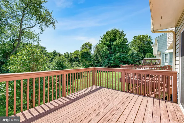 a balcony with wooden floor and fence