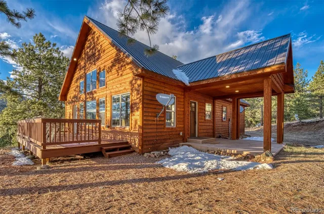 a view of a house with a wooden floor and a yard