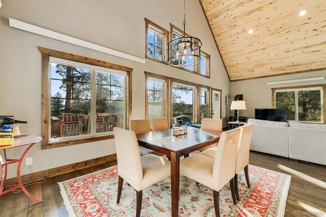 a view of a dining room with furniture wooden floor and a rug