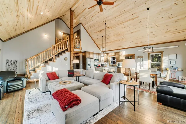 a living room with lots of furniture and wooden floor