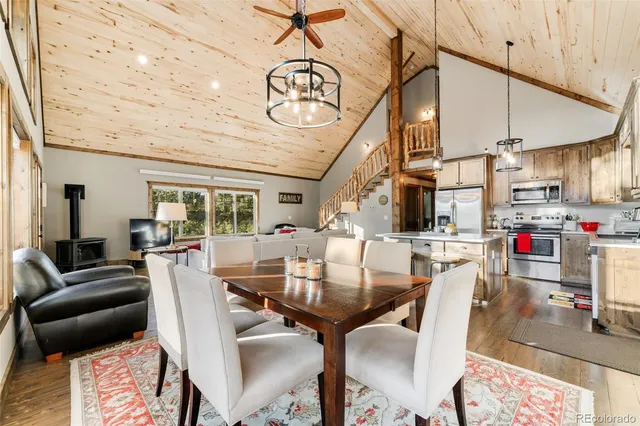 a view of a dining room with furniture wooden floor and chandelier