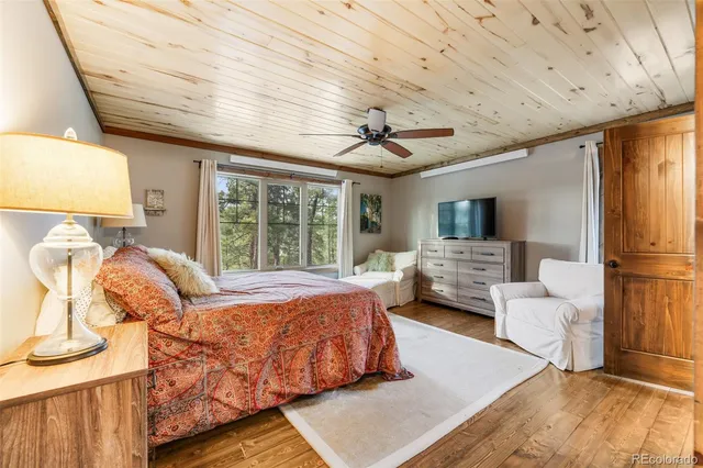 a bedroom with a bed couch and window