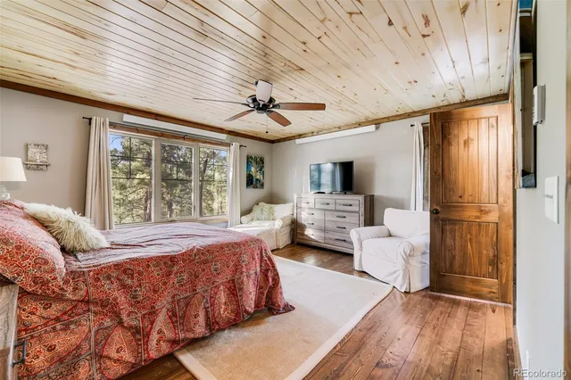 a bedroom with a large bed couch and a window