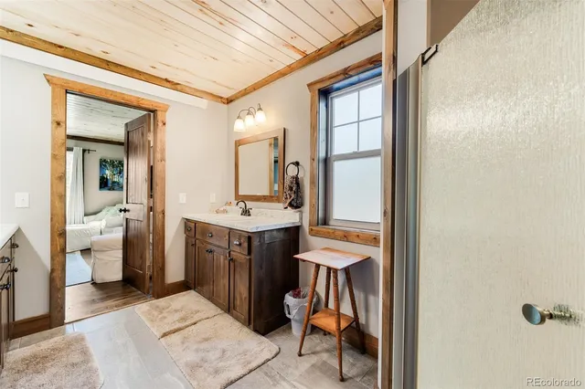 a bathroom with a toilet sink and mirror