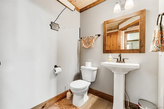 a bathroom with a sink a toilet and vanity
