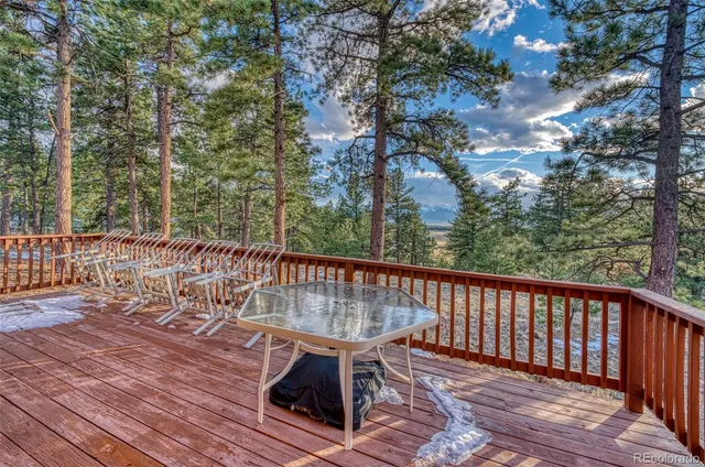 a view of a house with a yard and wooden fence