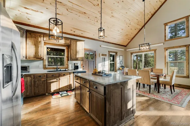 a kitchen with stainless steel appliances granite countertop a stove and cabinets