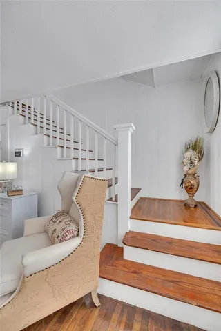 a view of entryway and hall with wooden floor