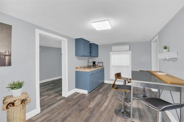 a room with a table chairs and wooden floor