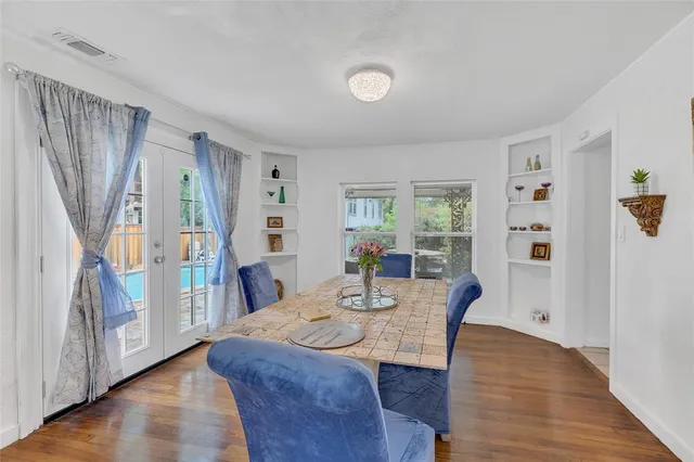 a view of a a dining room with furniture window and wooden floor
