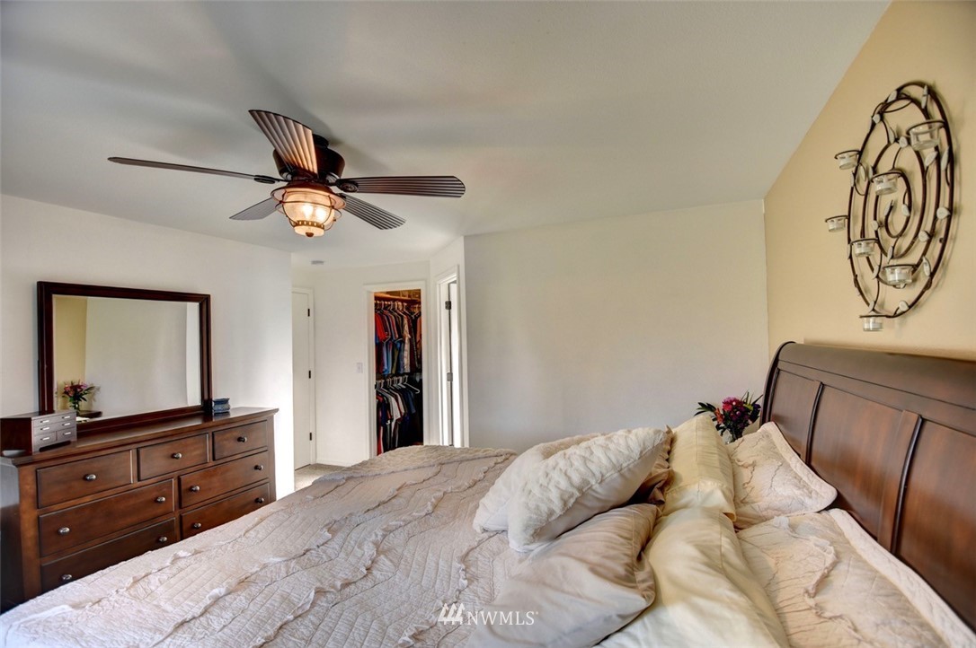 5124 183rd Lane Southwest Rochester, WA 98579 - Photo 12 of 31 a bedroom with a bed and a chandelier