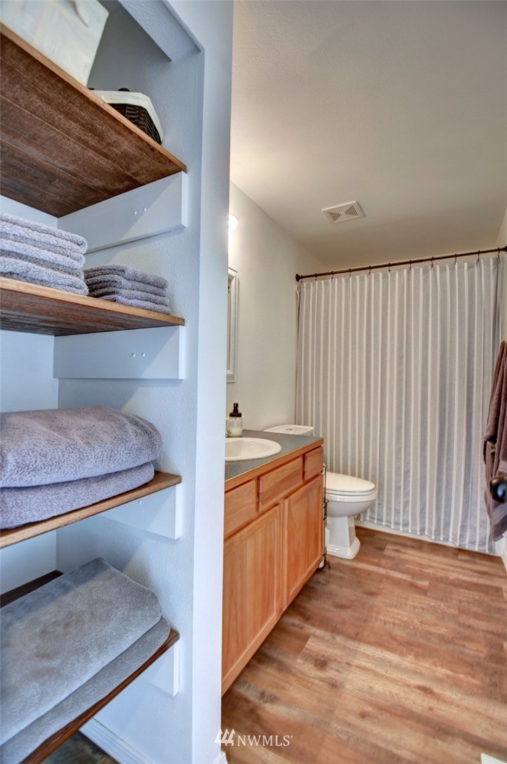 5124 183rd Lane Southwest Rochester, WA 98579 - Photo 16 of 31 a room with wooden cabinets and bed