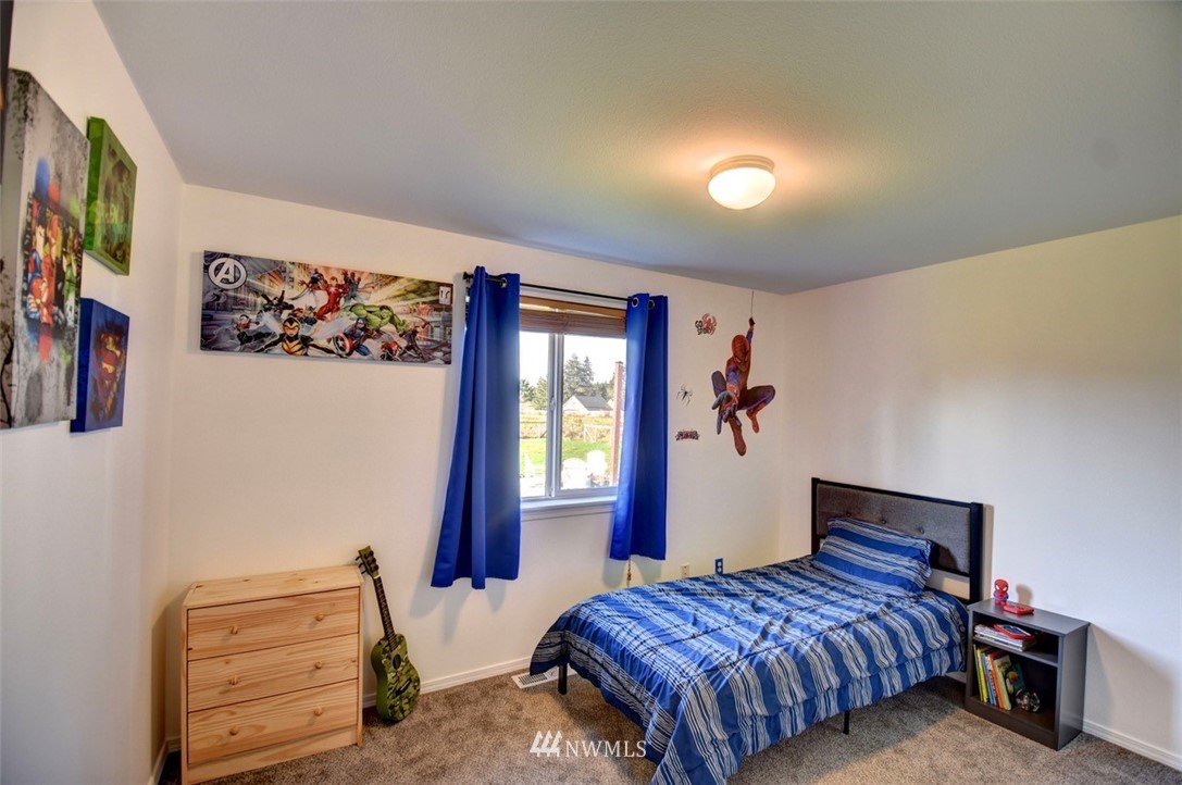 5124 183rd Lane Southwest Rochester, WA 98579 - Photo 17 of 31 a bedroom with a bed and a painting on the wall