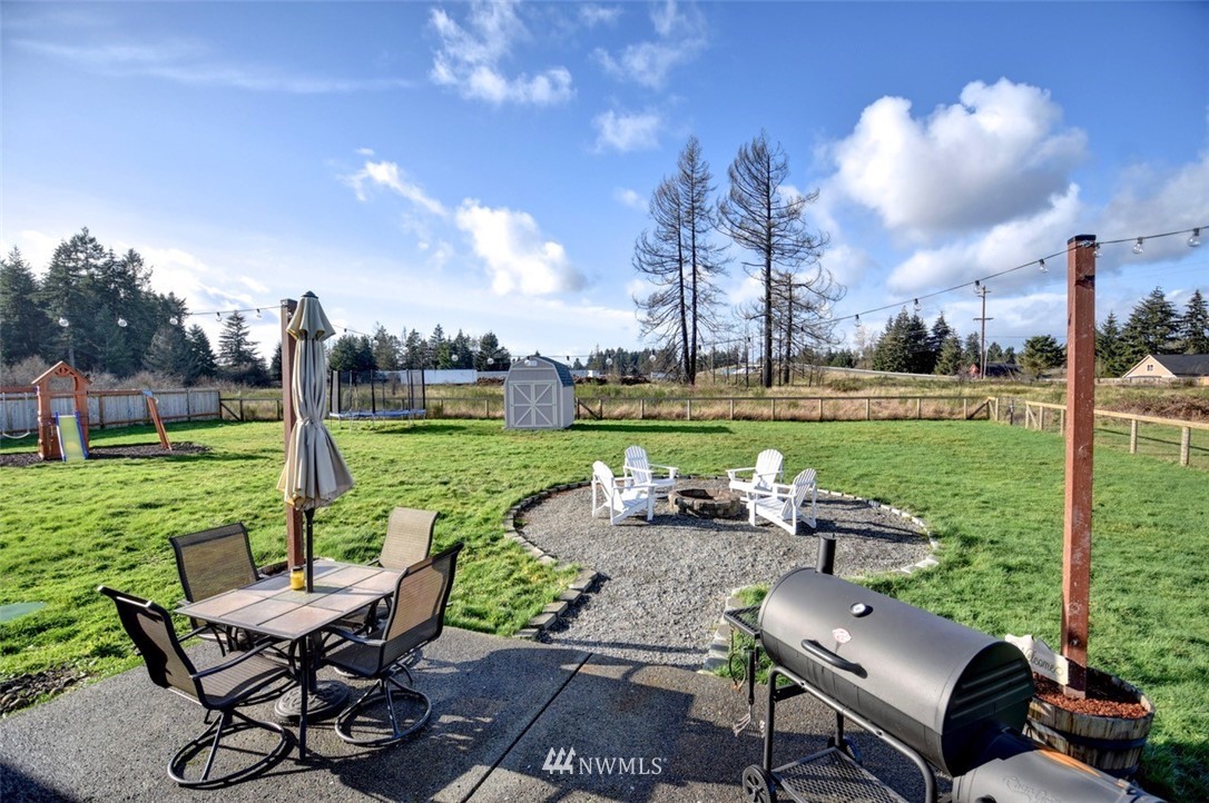 5124 183rd Lane Southwest Rochester, WA 98579 - Photo 23 of 31 a view of a patio with chairs and a table