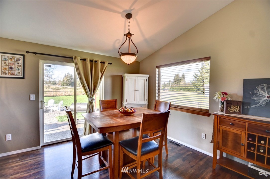 5124 183rd Lane Southwest Rochester, WA 98579 - Photo 4 of 31 a dining room with furniture a chandelier and wooden floor