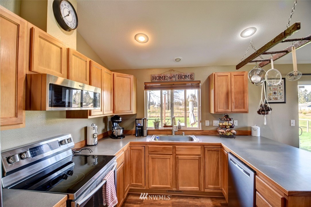 5124 183rd Lane Southwest Rochester, WA 98579 - Photo 7 of 31 a kitchen with stainless steel appliances a stove a sink a cabinets and a window