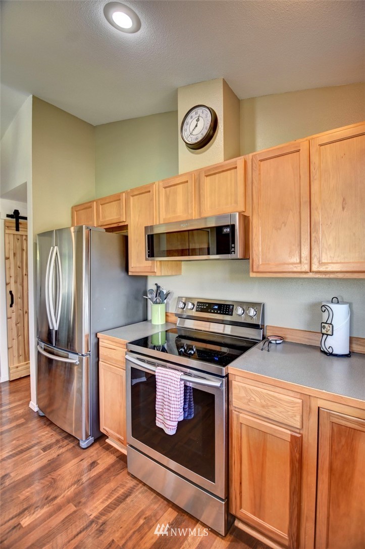 5124 183rd Lane Southwest Rochester, WA 98579 - Photo 8 of 31 a kitchen with stainless steel appliances granite countertop a stove and a refrigerator