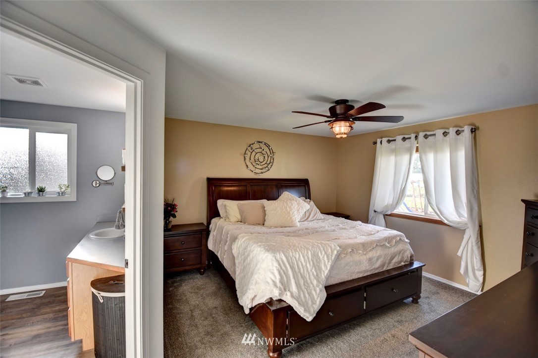 5124 183rd Lane Southwest Rochester, WA 98579 - Photo 9 of 31 a bedroom with a bed and a chandelier