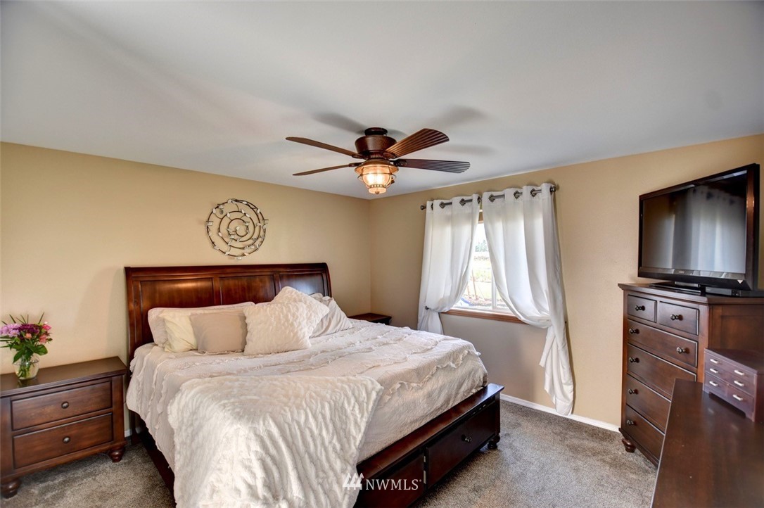 5124 183rd Lane Southwest Rochester, WA 98579 - Photo 10 of 31 a bedroom with a bed and a chandelier