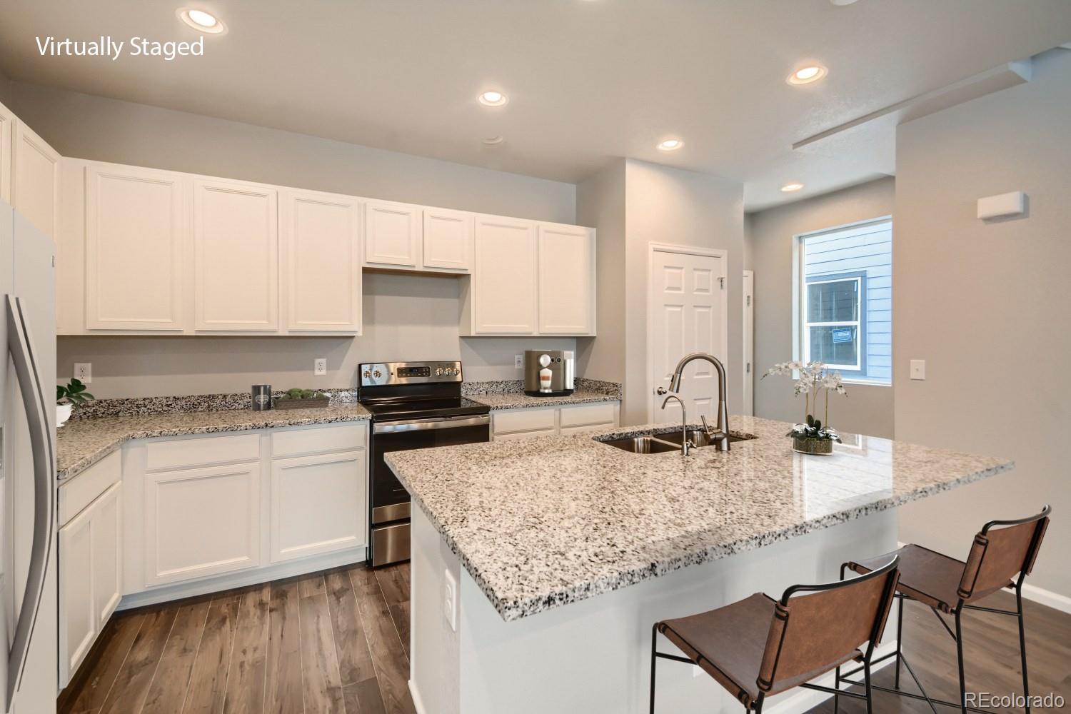 19032 High Point Boulevard Denver, CO 80249 - Photo 11 of 17 a kitchen with stainless steel appliances granite countertop a sink stove and cabinets