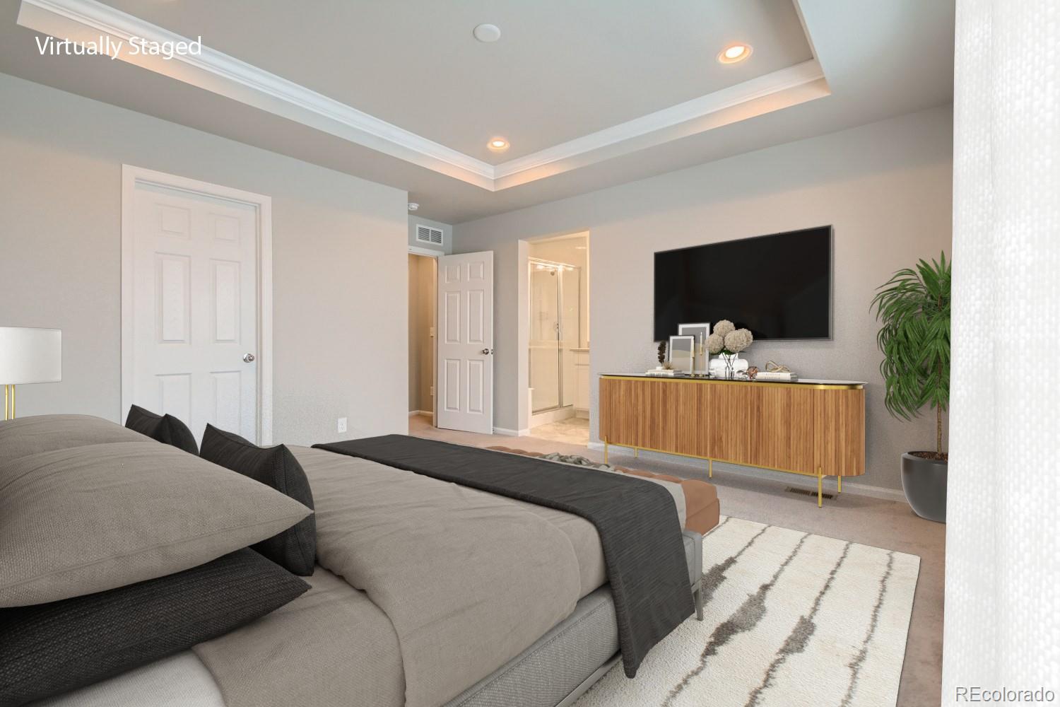 19032 High Point Boulevard Denver, CO 80249 - Photo 15 of 17 a bedroom with a bed and a flat screen tv