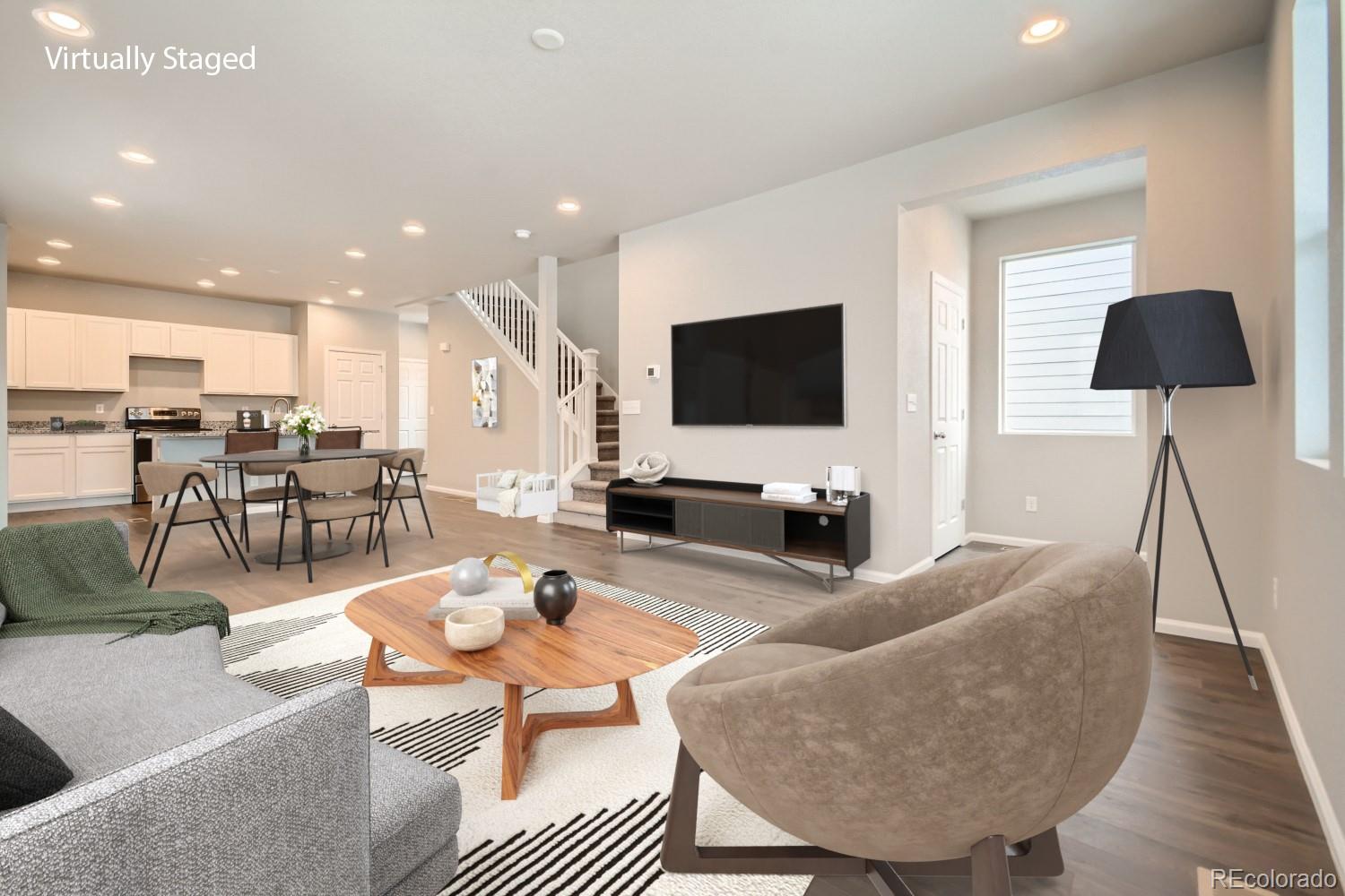 19032 High Point Boulevard Denver, CO 80249 - Photo 7 of 17 a living room with furniture and a flat screen tv