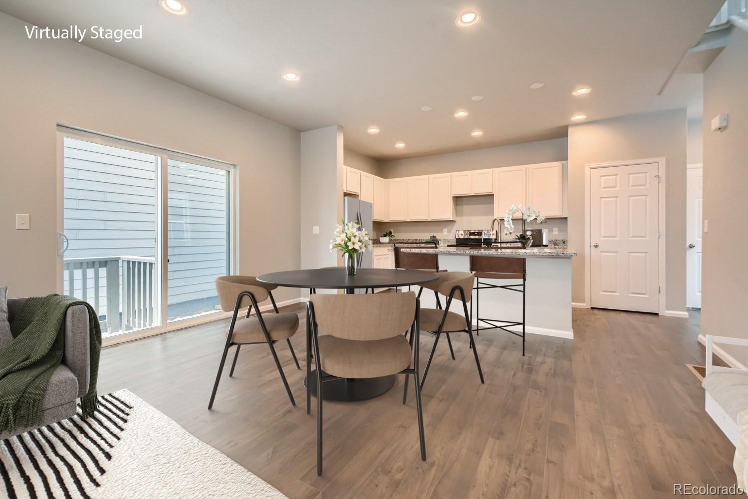 19032 High Point Boulevard Denver, CO 80249 - Photo 9 of 17 a view of a dining room with furniture window and wooden floor