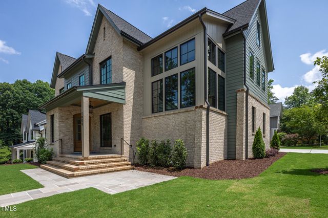 a view of a house with a yard and plants