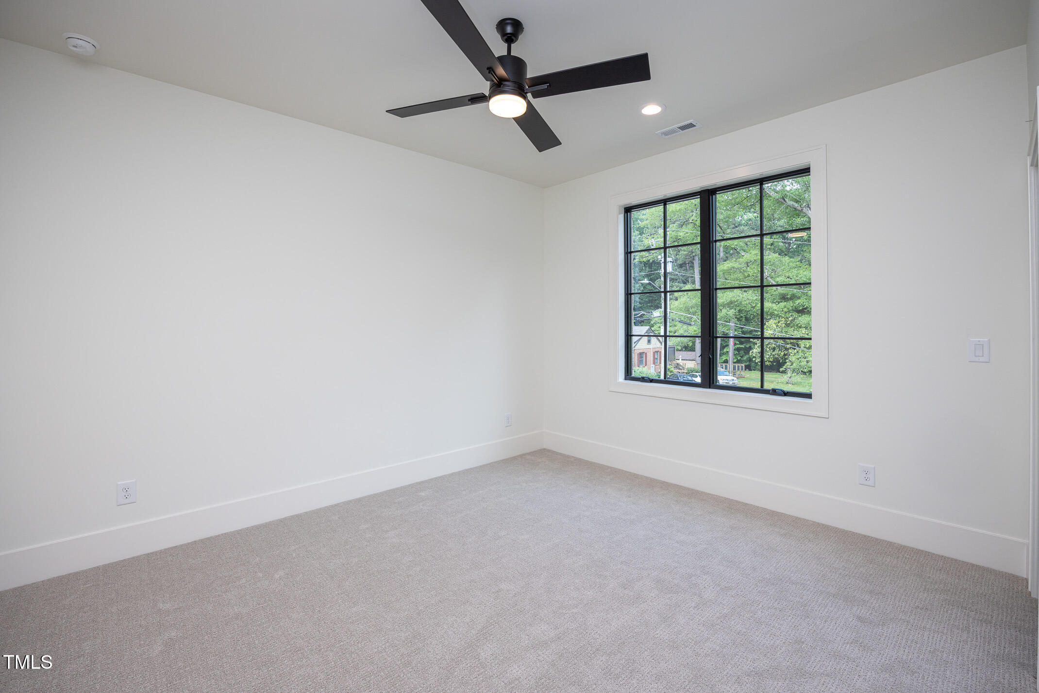 1000 Marilyn Drive Raleigh, NC 27607 - Photo 47 of 59 an empty room with a window and a fan