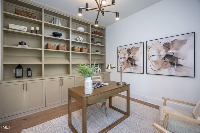 a living room with furniture a fireplace and a table