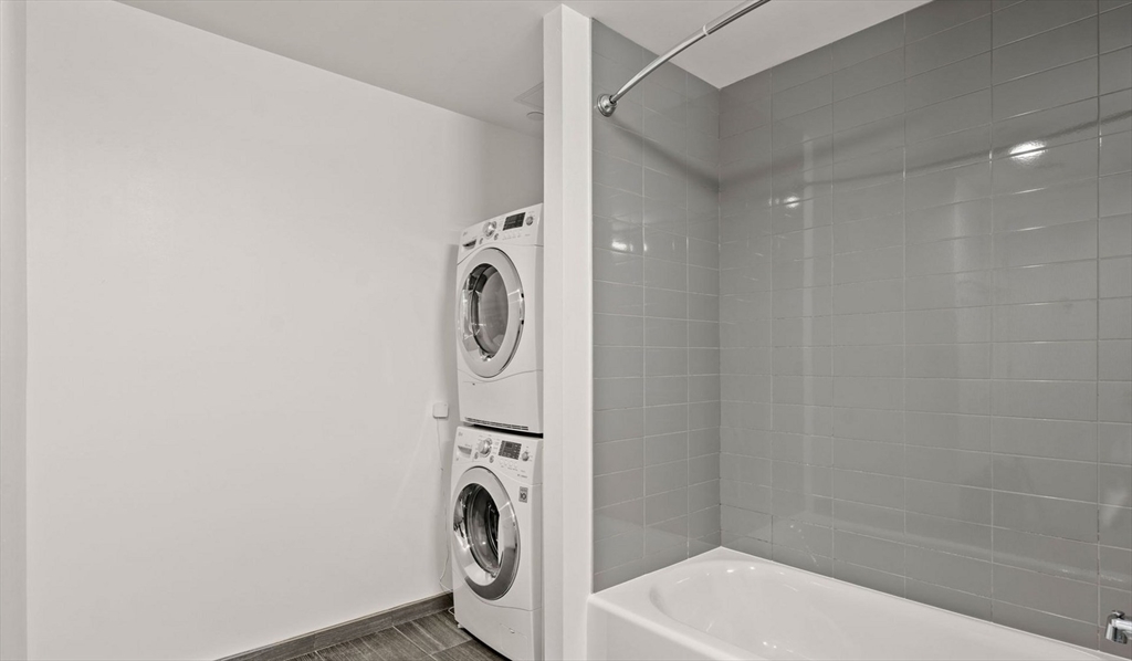 99 Kneeland Street, Unit 1908 Boston, MA 02111 - Photo 7 of 12 a bathroom with a sink a washer and dryer
