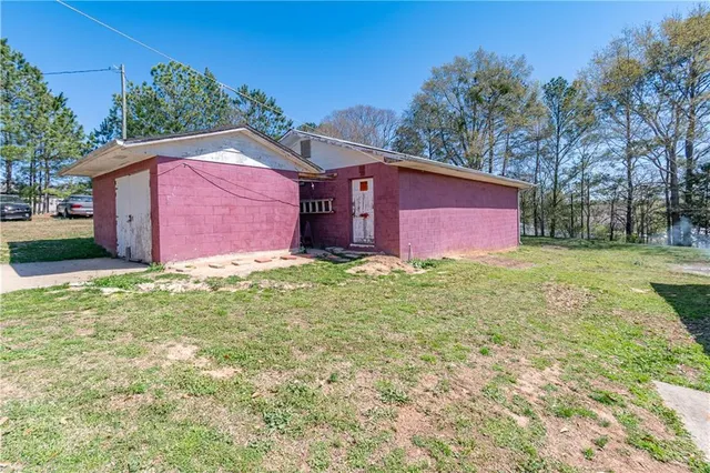 a large house with a big yard and large trees