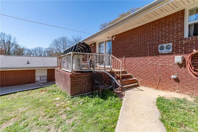 a view of a house with a yard and roof