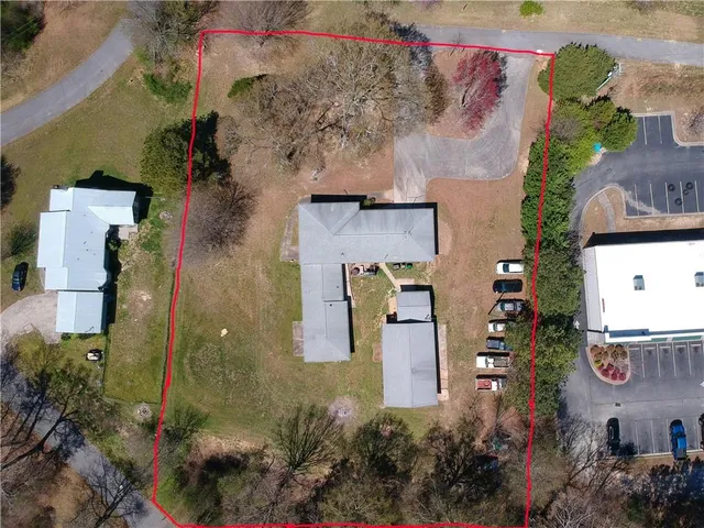 an aerial view of residential house with outdoor space and parking