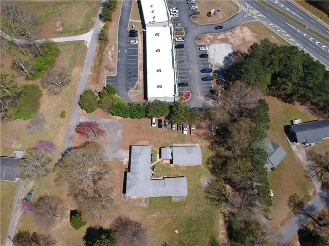 an aerial view of a residential apartment building with a yard